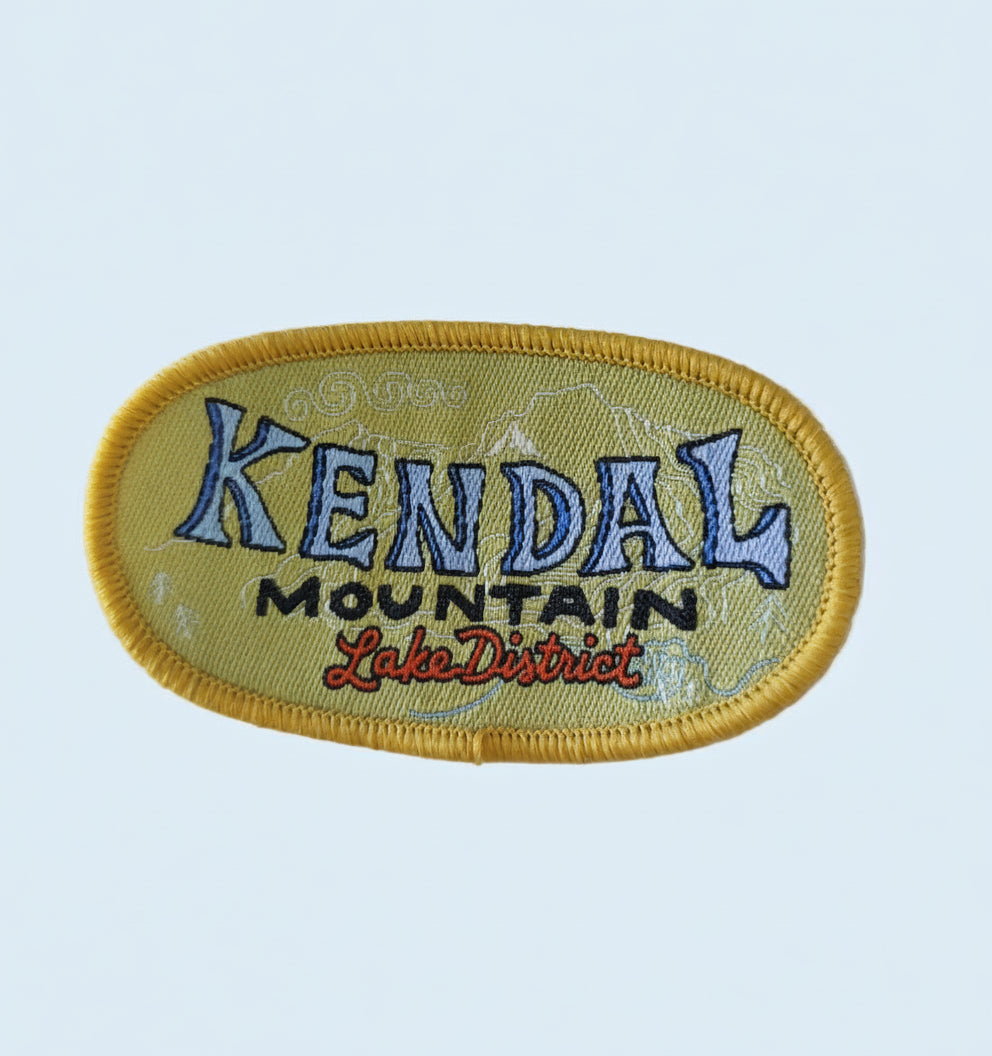 Embroidered patch with 'Kendal Mountain festival' text on a white background